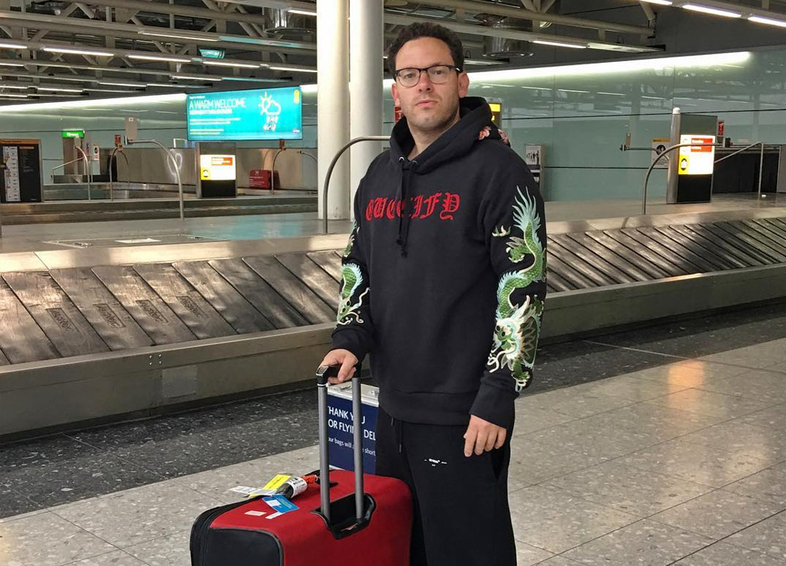sykes standing with luggage